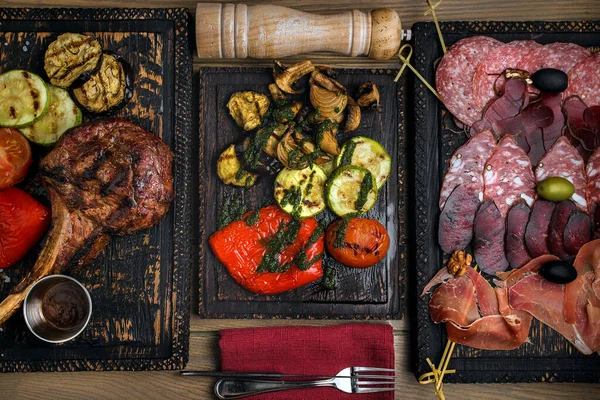 Grilled meat and vegetables on rustic wooden table. High quality photo