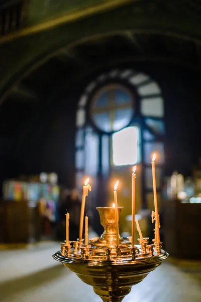 candles in the church on the stained-glass window. High quality photo
