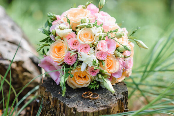 Beautiful tender wedding bouquet and rings. . High quality photo