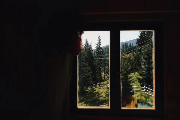 stock image View from the house in the forest. Window with a beautiful view on the mountains . Vacation home for the rest near the forest. High quality photo