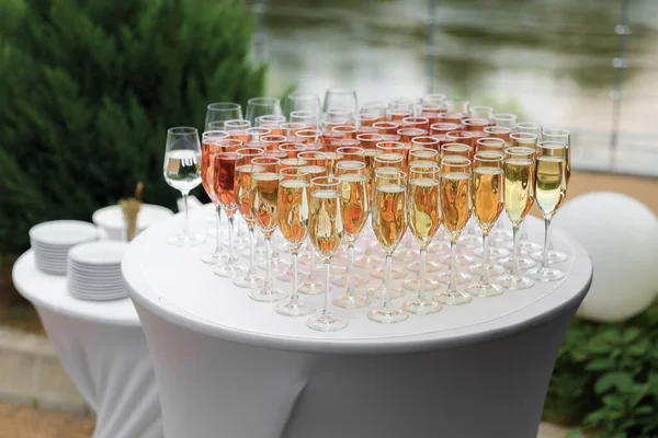 stock image a row of glasses filled with champagne are lined up ready to be served. High quality photo