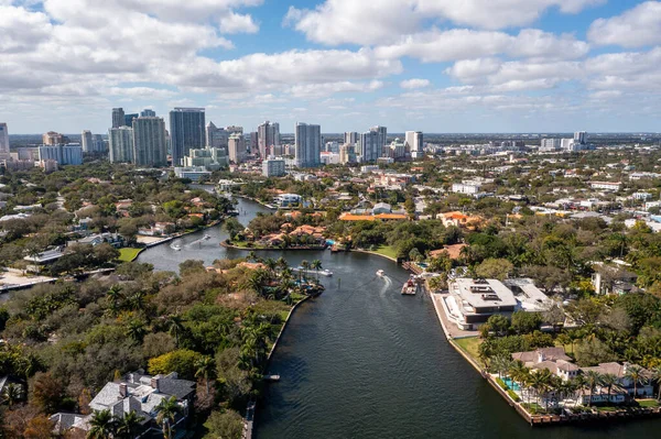 aerial drone shot of the new river in fort lauderdale, miami, surf, boats, docks, tropical plants, buildings and modern houses