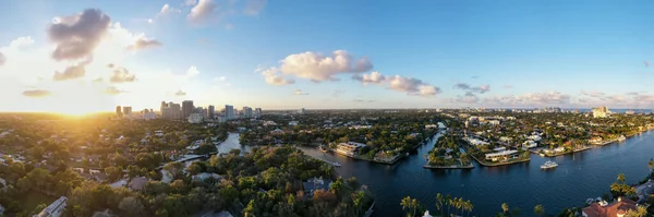 panoramic view of new river in fort lauderdale, miami, waves, boats, docks, tropical plants, buildings and modern houses