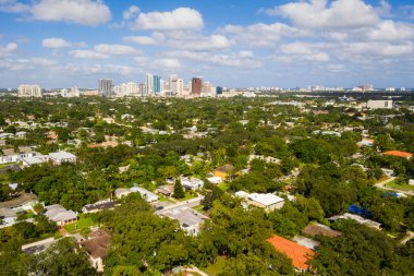 Aerial drone shot of elegant modern style houses in the Croissant Park neighborhood of Fort Lauderdale, tropical greenery around,