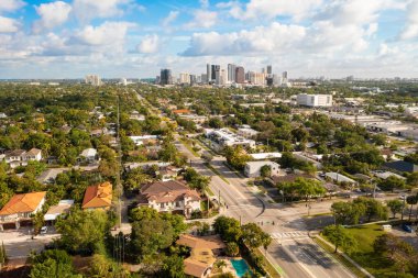 Aerial drone shot of elegant colonial style houses in the Croissant Park neighborhood of Fort Lauderdale, tropical vegetation around,