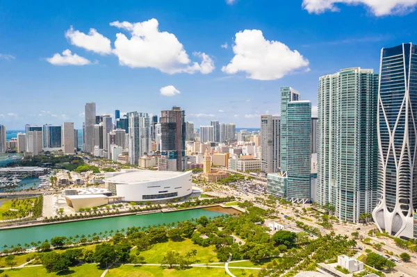 Aerial drone view of Downtown Miami, with spectacular modern and luxurious buildings and towers, streets with cars, sea in the background with blue and imposing sky