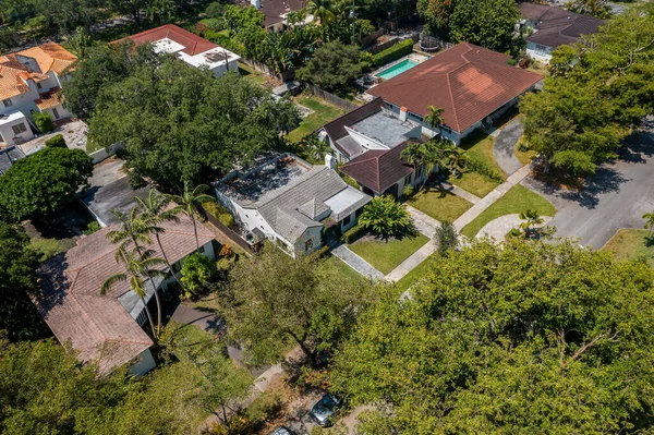 stock image Aerial drone shot of suburb in Miami Shore village, Miami Dade County, with large tropical vegetation around, modern houses with elegance and style, summer weather, blue sky