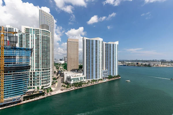 stock image Aerial shot from a drone of the Brickell Key area, with a lot of towers and modern buildings, commercial urban landscape, surrounded by sea and canals, boats sailing, piers, bridges, avenues, blue sky and turquoise sea