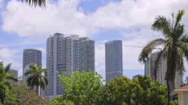 Florida, USA. Modern building with swimming pool, trees, chairs. Urban landscape with blue reflecting pool, city architecture, and scenic environment.