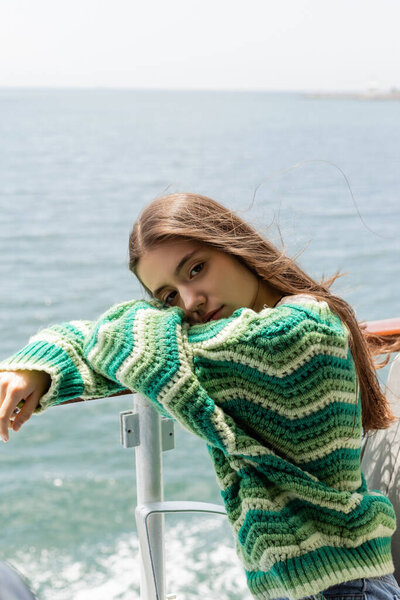 Young brunette woman looking at camera during cruise on yacht in Turkey 