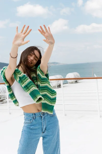 Carefree traveler with sweater outstretching hands during cruise in Turkey — Stock Photo