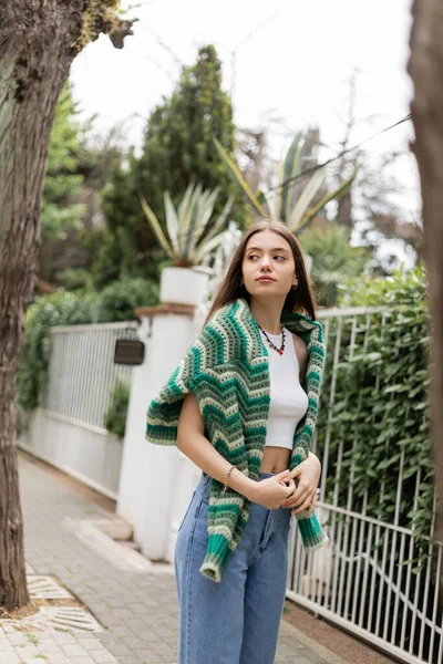 Young woman in top and knitted sweater standing on street in Istanbul — Stock Photo