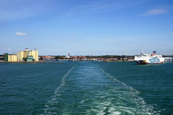 stock image SWEDEN, YSTAD - CIRCA JULY 2022: Entrance to the port. Visible fairway of the ship and departing Polferries ferry.