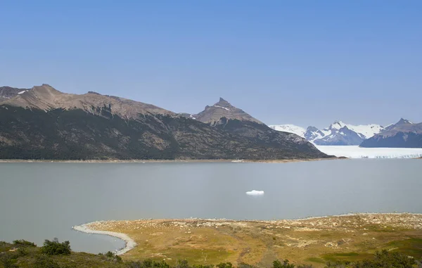 Landscape of Lake Argentino with glaciers in the background and mountains.