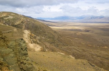Patagonian desert landscape with mountains and valleys.