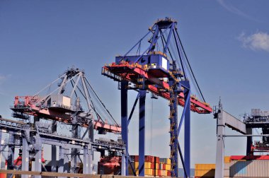 Crane lifting heavy cargo into a container at a busy port, symbolizing global and international trade. Global business logistics transport import export and International trade concept, Logistics distribution of containers. clipart