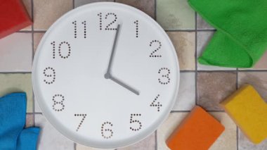 4 oclock. Cleaning time. Timelapse. Clockwise movement of clock hands after four oclock. Clock, kitchen cleaning sponge, microfiber cloth on tiled wall background. Tips for quick house cleaning