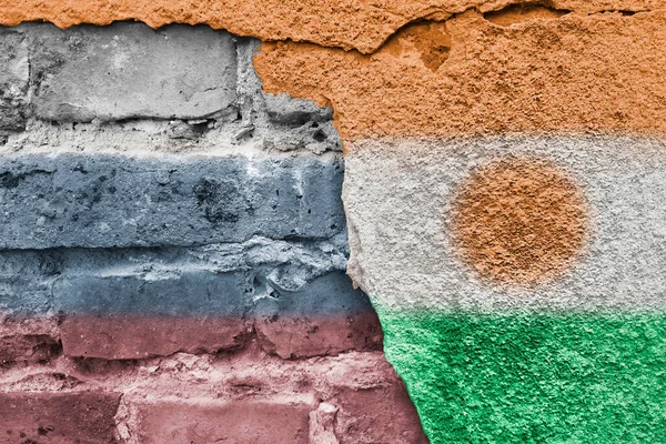Flags of countries on background of a brick wall. Niger and Russia. Interaction and partnerships between countries. World oversights of influence.