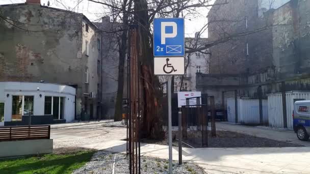 残疾人停车标志 欧洲城市住宅区庭院背景下的信息路标停车和轮椅人签名 Sosnowiec Poland Europe 2024 — 图库视频影像