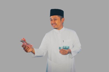 Asian moslem man donate his money clipart