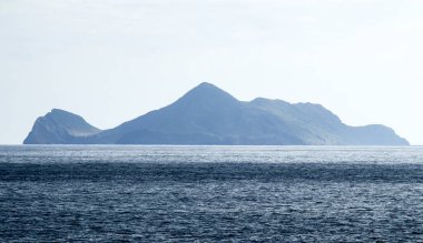 an island shaped like a turtle in the middle of the sea