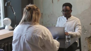 Moda ofisinde dizüstü bilgisayarın önünde genç bir erkekle iş görüşmesi. Yüksek kalite 4k görüntü