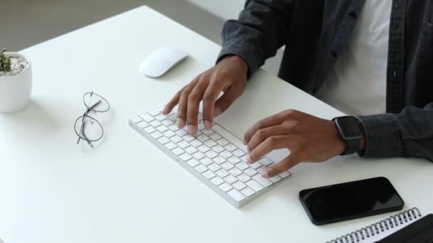 男性アフリカ系アメリカ人のユーザーの手は ノートパソコンのキーボードを入力してテーブルに座って 混合人種の民族学生の専門家の研究作業は Pcソフトウェア技術の概念と 最大ビュー4K 高品質 — ストック動画
