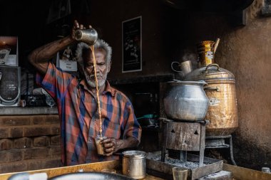  Tamil Nadu, India - 01-15-2023 - Local man preparing masala chai on the street . High quality photo