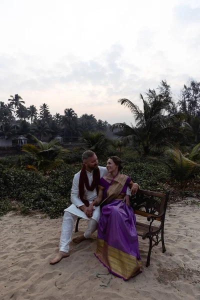 Wedding of a couple from Europe in India. A light skinned man in a traditional Indian men. white skin. Bride in beautiful sari with mehendi. Caucasian marriage . High quality photo