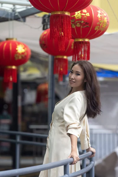 Chinese lanterns. Beautiful Asian girl in white dress with attractive facial structure, ideal for makeup hair modeling. High quality photo