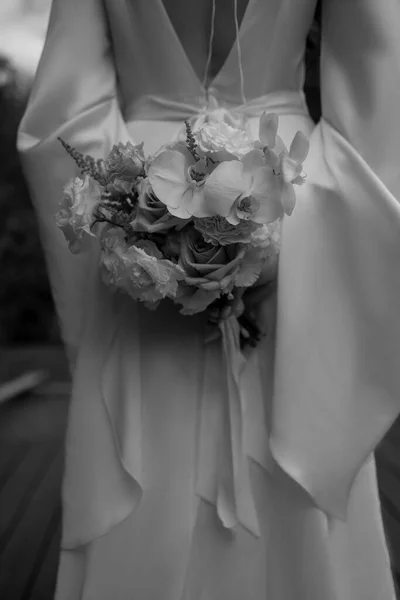 stock image young girl in a white wedding dress holds in her hands a bouquet of flowers. High quality photo