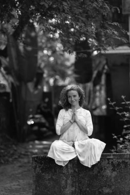  Kızıl saçlı bir kız Hindistan 'da güneşli bir günde ağaçların gölgesinde yoga yapıyor. Yüksek kalite fotoğraf