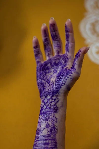 Applying Beautiful henna art on hands. Bridal design. Wedding Mehendi. Indian arabian culture of wedding mehendi Drawing process of henna menhdi ornament on womans hand hands of a tourist in henna.