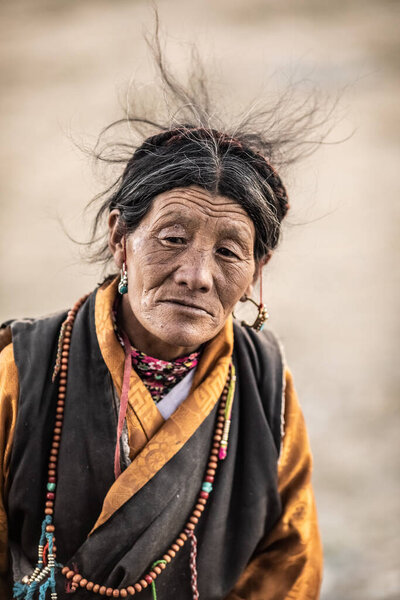 China, January 1st, 2019: Portrait of a resident of the Tibet Autonomous Region. Nomadic people of Tibet. High quality photo