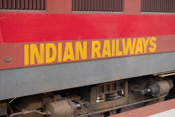 The inscription Indian Railways is displayed on a red Indian train, representing public transportation in India. High quality photo