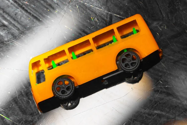 plastic model of a yellow school bus, showcasing a nostalgic representation of childhood and transportation. yellow school bus plastic toy model. High quality photo