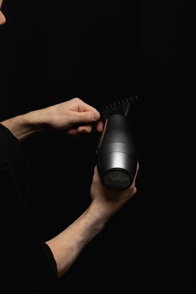 hair dryer and comb in barbers hands. High quality photo