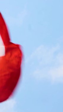 İsviçre Konfederasyon bayrağı rüzgarda dalgalanıyor. Avrupa ülkesinin İsviçre ulusal bayrağı. Bulutlu bir arka plan. Yüksek kalite 4k görüntü