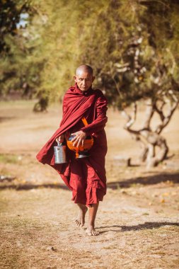 BAGAN, MYANMAR - Nisan 02, 2018: Budist rahibe yardımcısı Myanmar Thatbyinnyu Pagoda, Bagan 'ın önünde yürüyor. - Evet. Yüksek kalite fotoğraf
