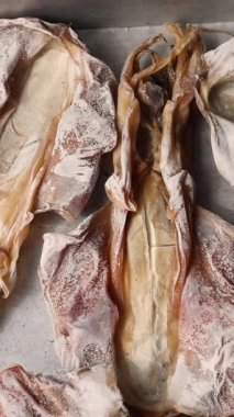 Asya pazarında kurutulmuş mürekkep balığı. Geleneksel bir lezzet Güneydoğu Asya 'da popüler. Yerel yemeklerde atıştırmalık ya da bulaşık malzemesi olarak kullanılır. Otantik sokak yemeklerinin canlı bir örneği. Yüksek kalite 4k görüntü