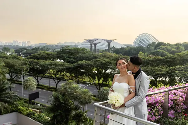 Güzel bir düğün çifti arka plan olarak Singapur Körfezi 'nde Gardens' ı öpüyor. Damat ve gelin, Changi Havaalanı 'na vardıktan sonra Marina Körfezi' nden Singapur 'un bahçesine giden köprüdeler. Yüksek kalite fotoğraf