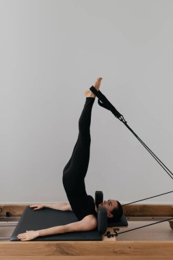 Pilates yenilikçi eğitim makinesi. Spor salonunda spor yapan bir kadın. Yüksek kalite fotoğraf