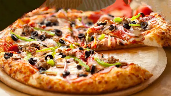 stock image pizza with ham, mushrooms and olives.