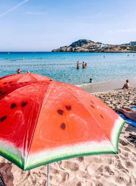 beach with red umbrellas on the sea coast