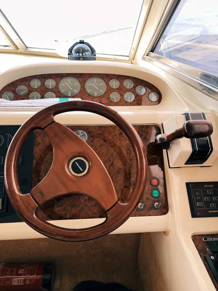 luxury yacht steering wheel with the dashboard of a cockpit of the open air.