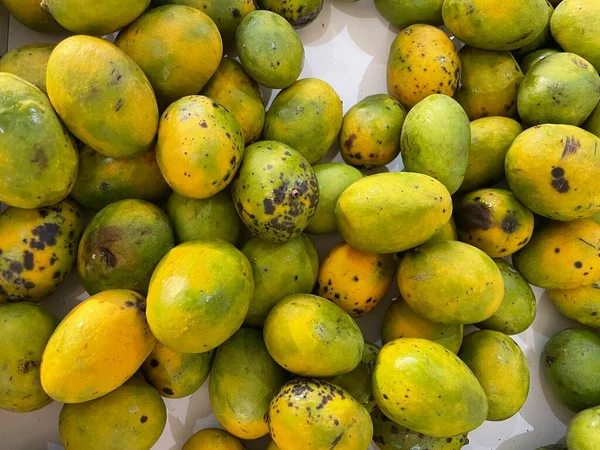 a lot of juicy yellow mangoes in the market.