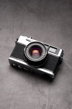 Old film camera isolated on dark background clipart