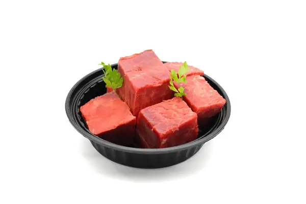 Fresh Raw Beef Cubes in Black Bowl Isolated on White Background