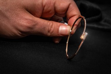 Elle dikkatlice tutulan narin bir gül altın çerçeveli çok güzel yapılmış elmas bir bilezik. Bu lüks bilezik her kıyafete biraz sofistike bir dokunuş, zarafet ve çağdaş tasarım katmak için mükemmeldir..