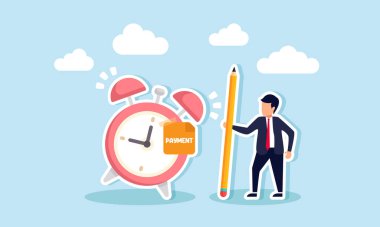 Elinde kalem olan bir işadamı, üzerinde Ödeme Zamanı yazan bir çalar saatin yanında duruyor. Fatura ödeme tarihinin hatırlatıcısı.